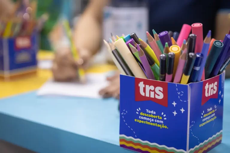 Caixa com lápis de cor e canetas da marca Tris, ideal para lista de material escolar.